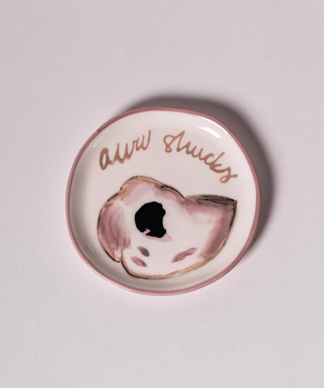 Round ceramic plate with an oyster design and aww shucks text in cursive.