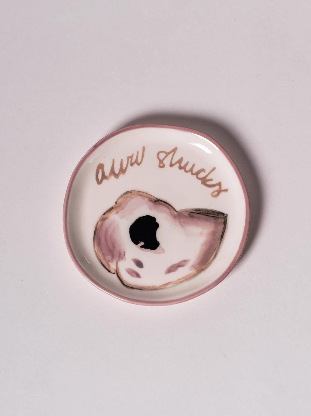 Round ceramic plate with an oyster design and aww shucks text in cursive.